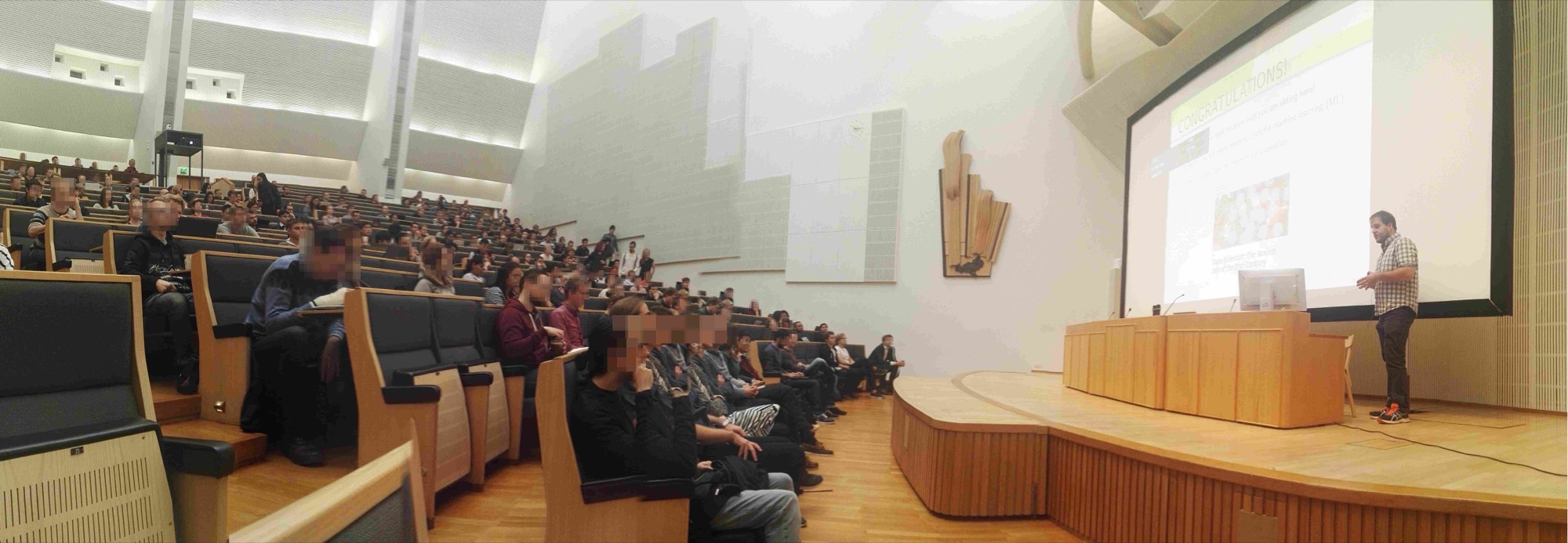 Alexander Jung lecturing to a packed lecture hall at Aalto University